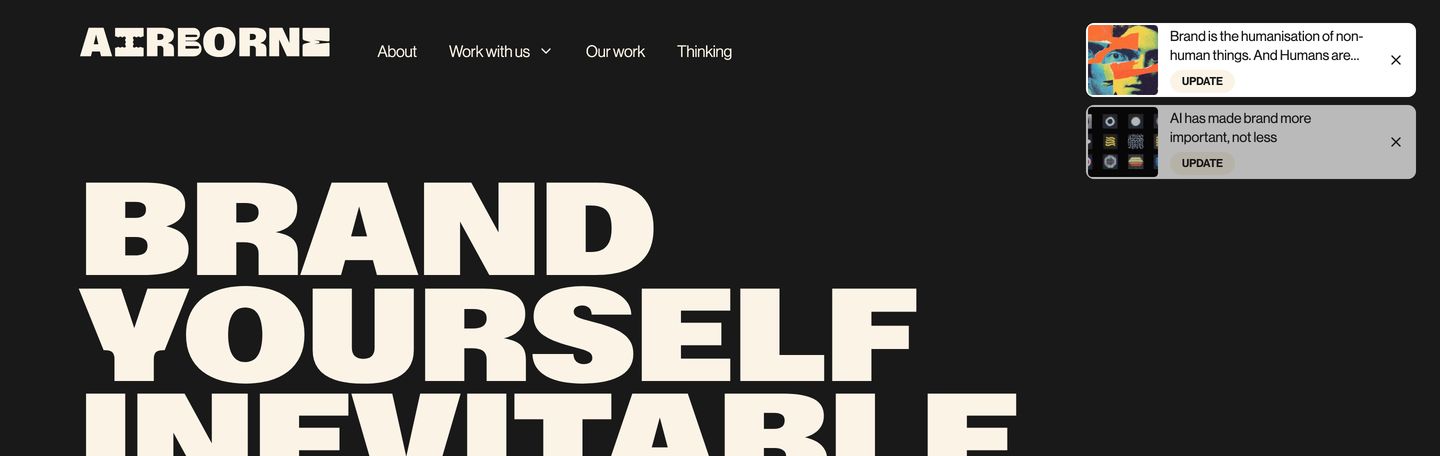 Massive high-contrast typography commands a dark canvas punctuated by minimalist floating update cards.