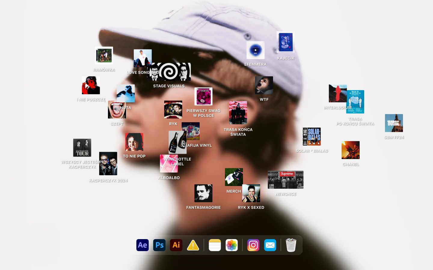 An interactive desktop-OS inspired creative portfolio hero layering scattered album artwork and project icons across a blurred portrait backdrop.