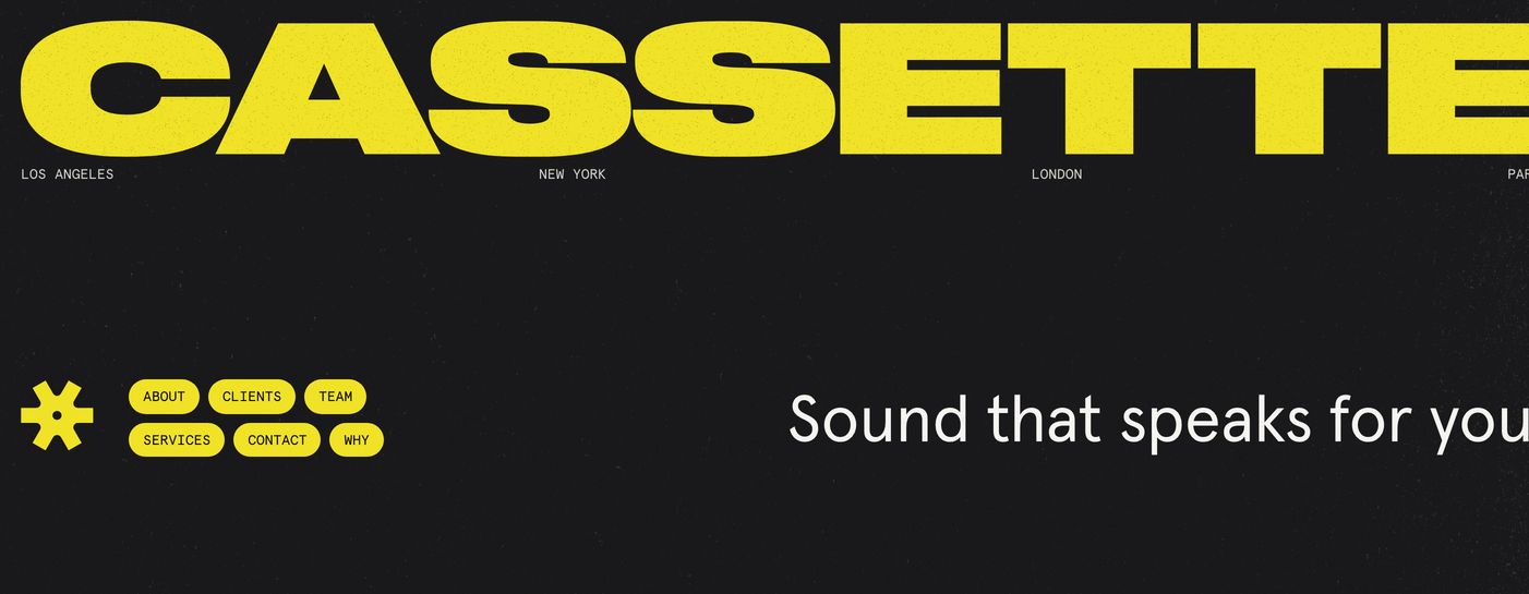 Punchy dark hero anchored by a massive acid-yellow wordmark and asymmetric tactile pill navigation.