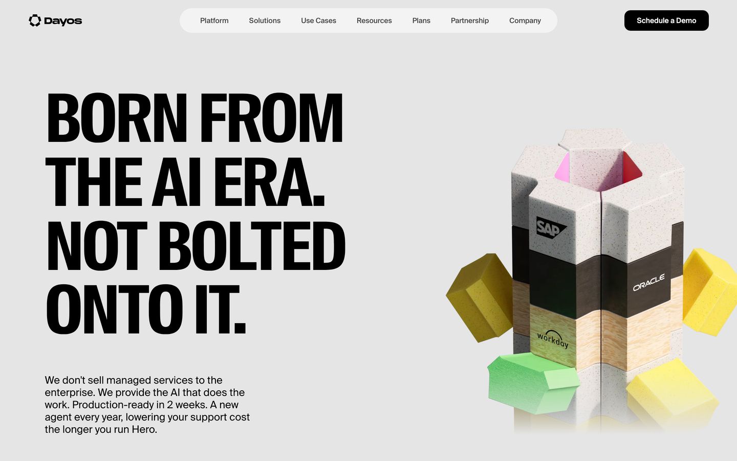 Massive condensed black typography makes a defiant statement beside a modular, tactile 3D puzzle column on clean grey.