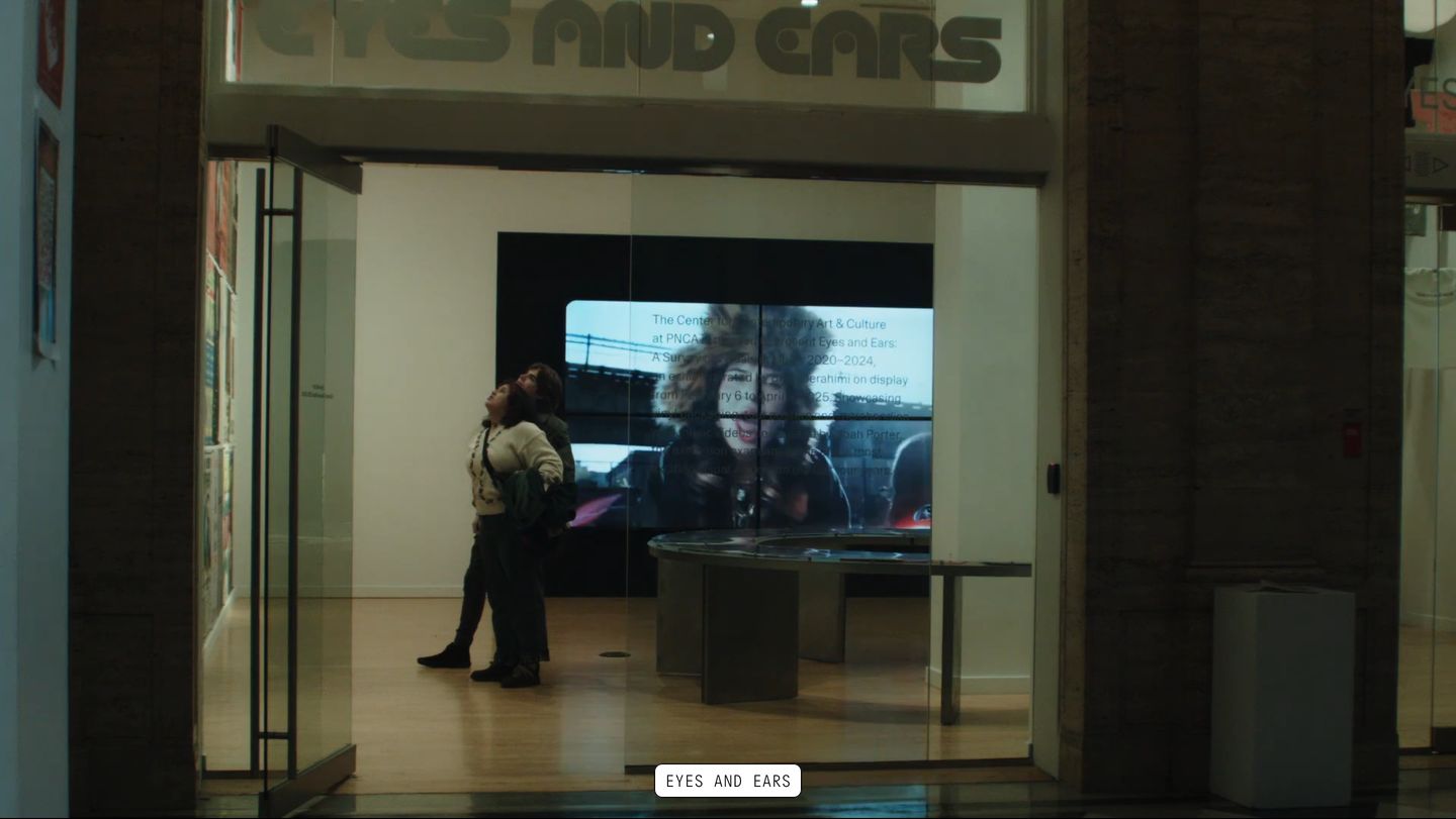 Atmospheric full-bleed exhibition video providing an immersive documentary view anchored by a minimal uppercase floating label.