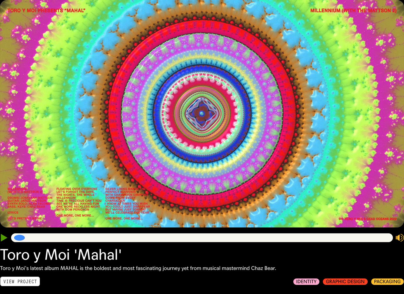 Vibrant psychedelic kaleidoscope artwork dominates a customized dark video player embed framed with clean metadata and colourful tag pills.