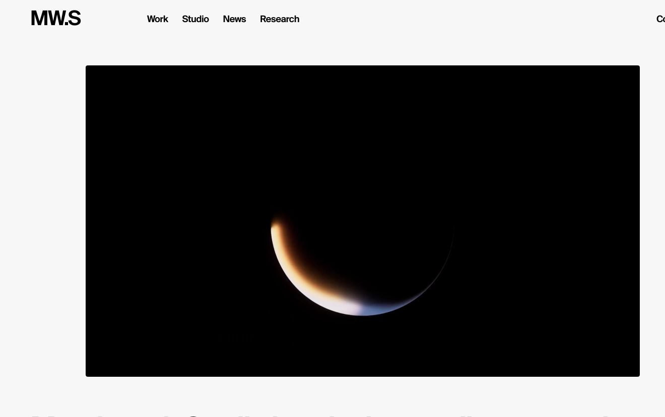A quiet, minimalist studio header framing a dark cinematic video window against an expansive light canvas.