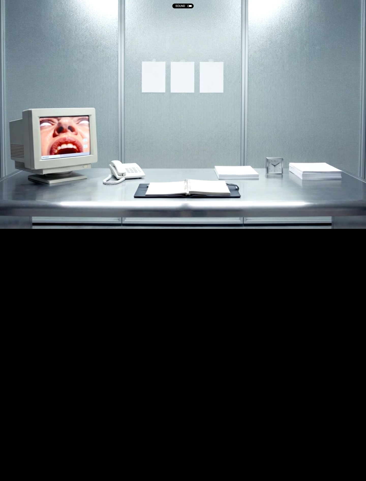 A surreal, dystopian office installation featuring a vintage CRT monitor screaming in an eerie, sterile cubicle above total blackness.