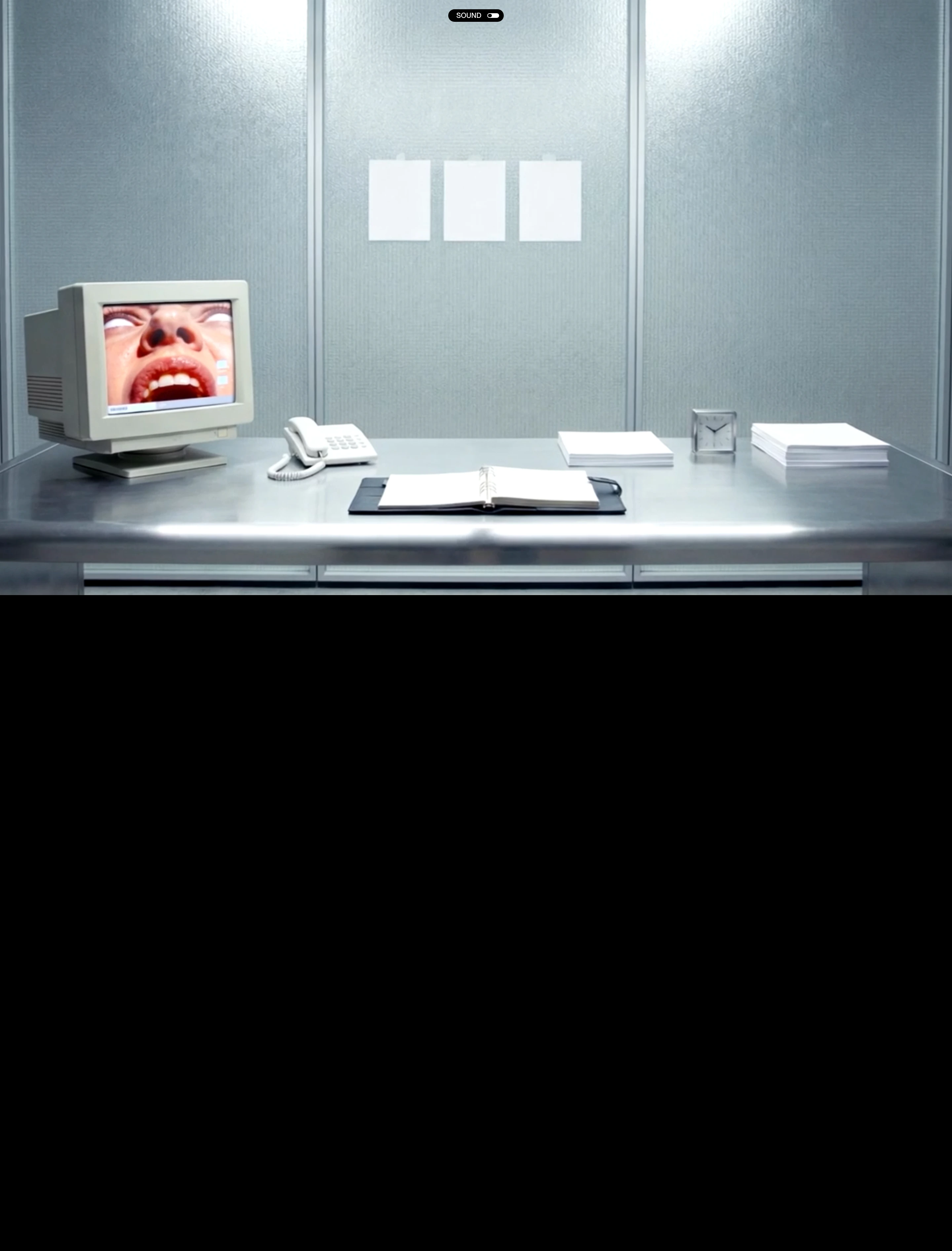 A surreal, dystopian office installation featuring a vintage CRT monitor screaming in an eerie, sterile cubicle above total blackness.