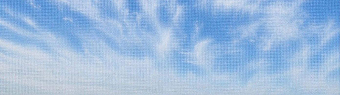 An airy and expansive panoramic sky banner treated with a subtle halftone print texture.