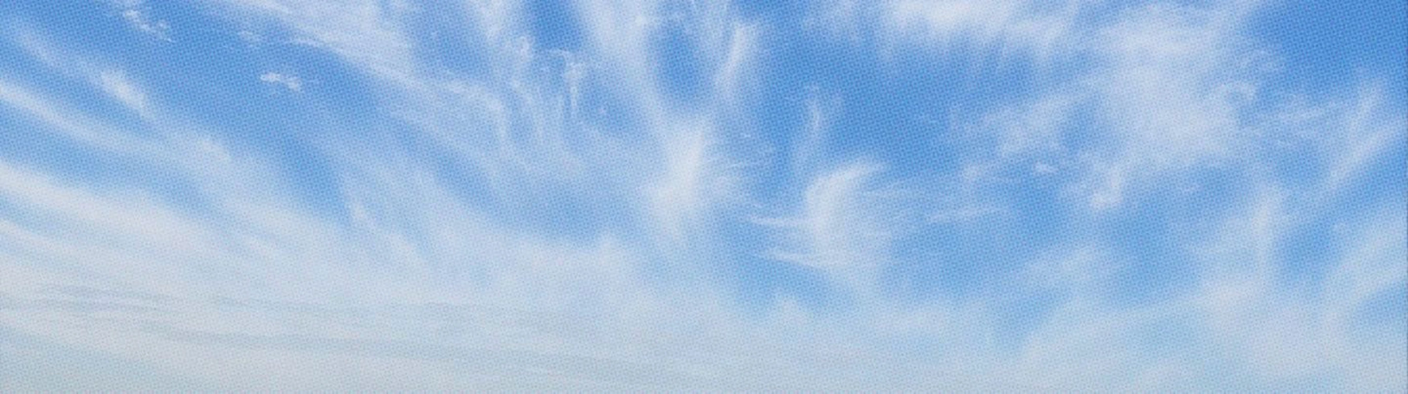 An airy and expansive panoramic sky banner treated with a subtle halftone print texture.