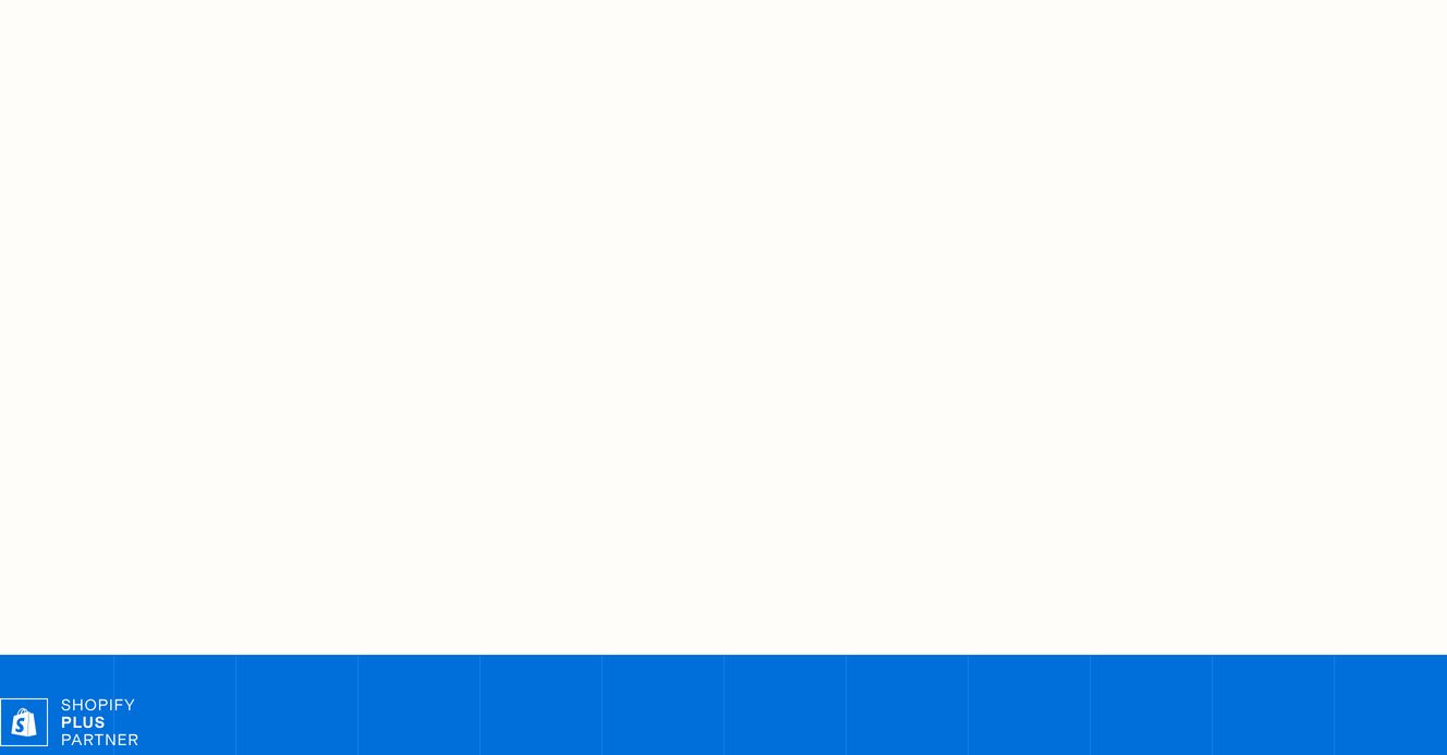 An expanse of quiet white space anchored at the base by a vibrant blue modular Shopify partner badge.