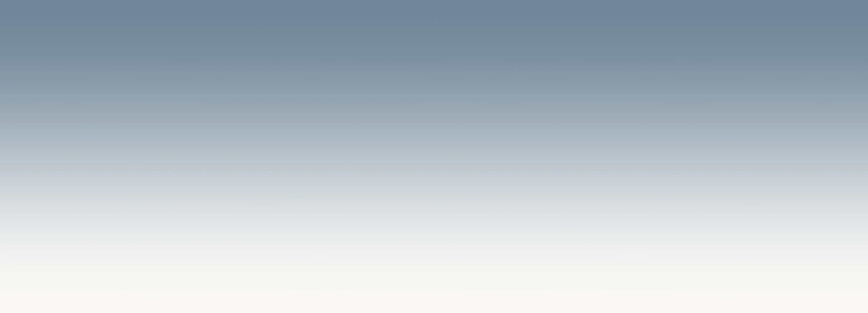 An empty, serene transitional gradient fading softly from a dusty slate blue into warm off-white.