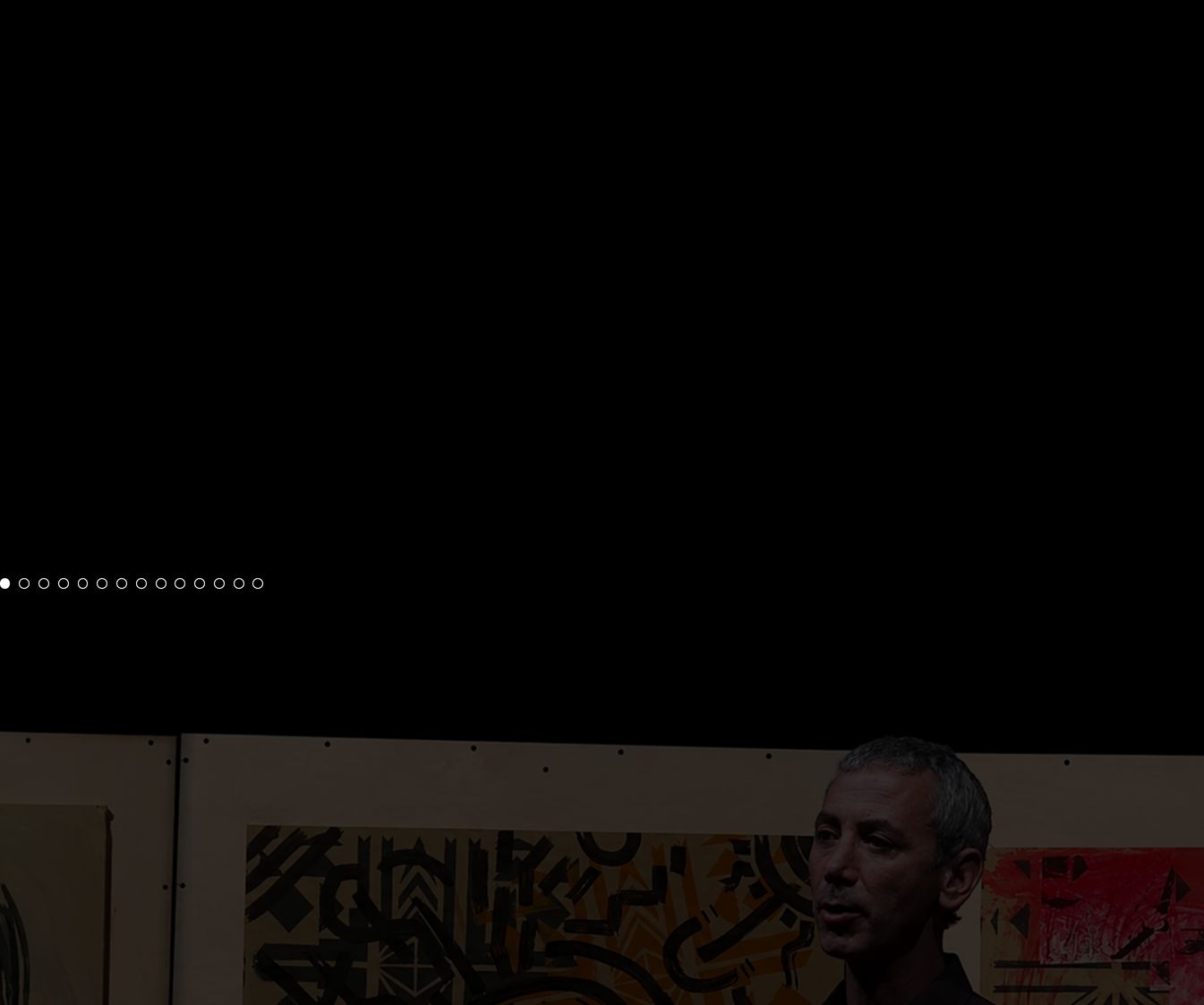 Atmospheric, dark showcase dominated by deep shadows with subtle pagination dots and documentary photography peeking from below.