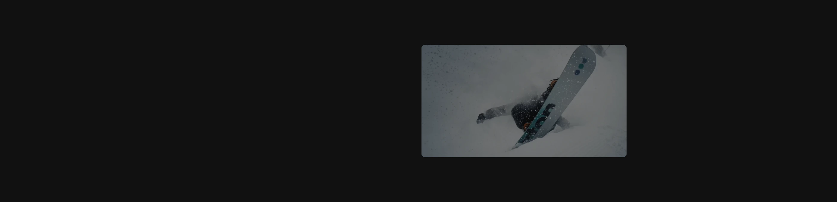 An expansive dark canvas framing an isolated, offset photographic glimpse of snowboarding action.