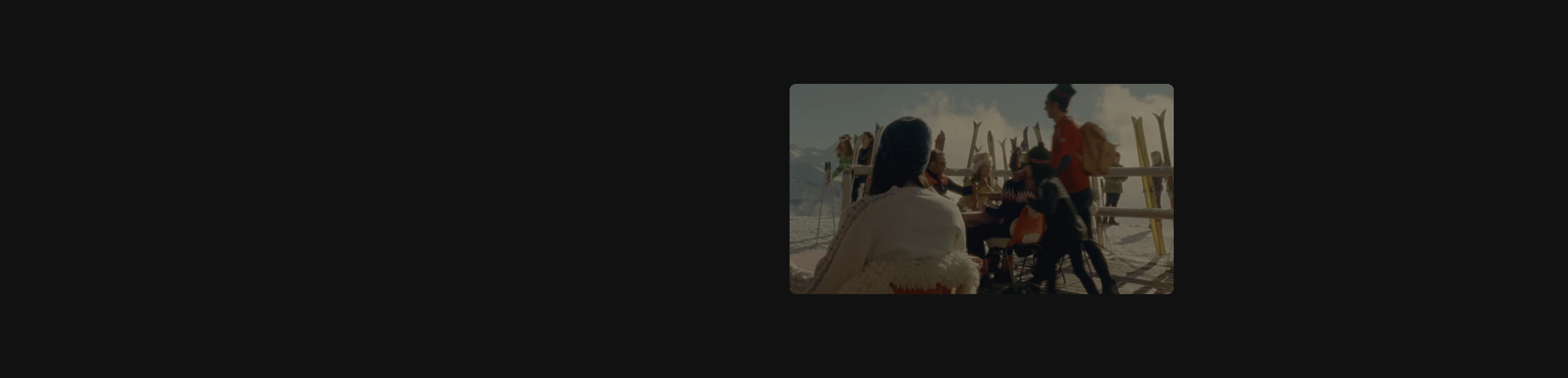 A quiet, atmospheric showcase with a solitary vintage ski photograph suspended in an expansive dark void.