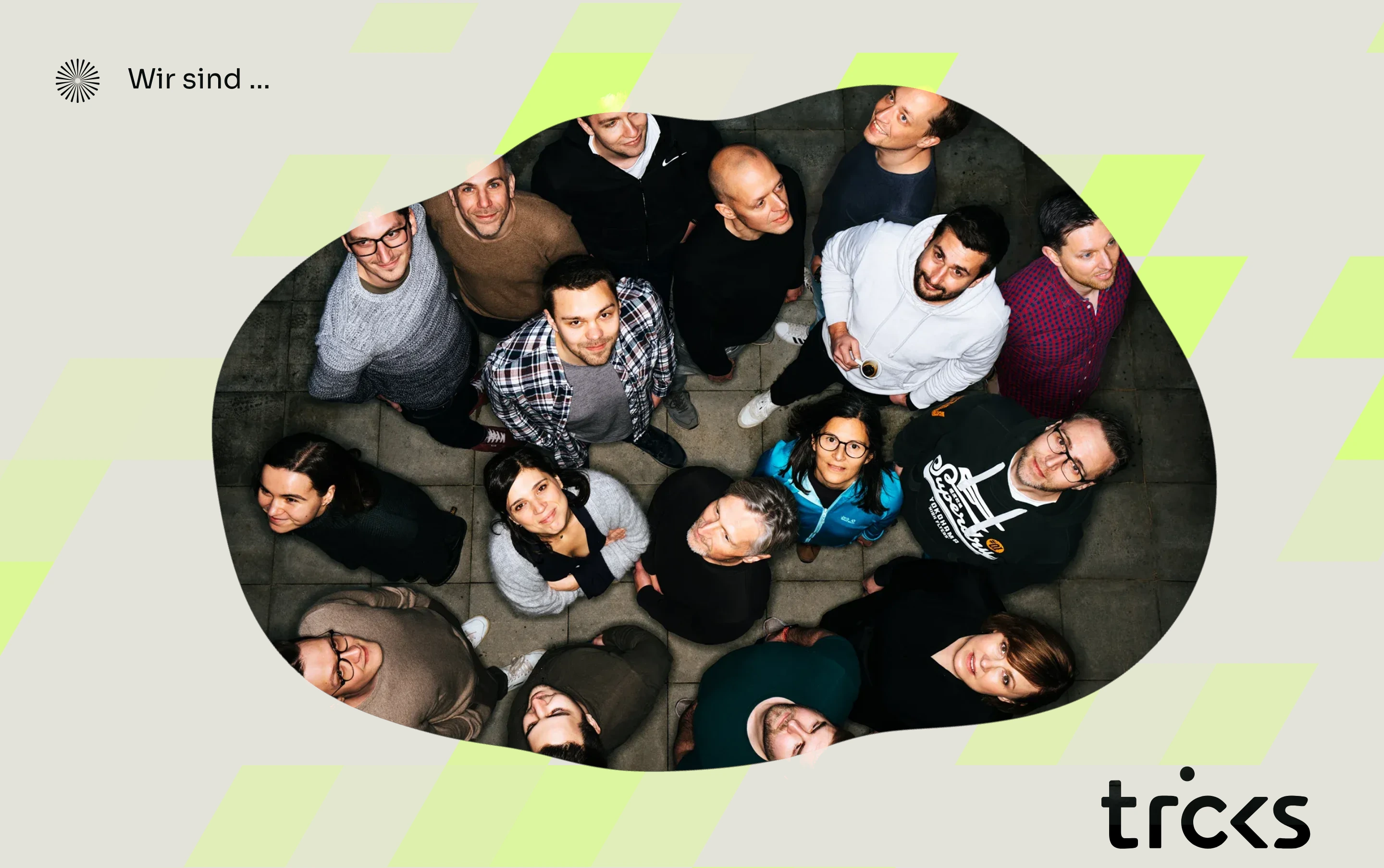 An overhead team portrait framed inside an organic cutout on a neutral canvas with neon geometric accents.