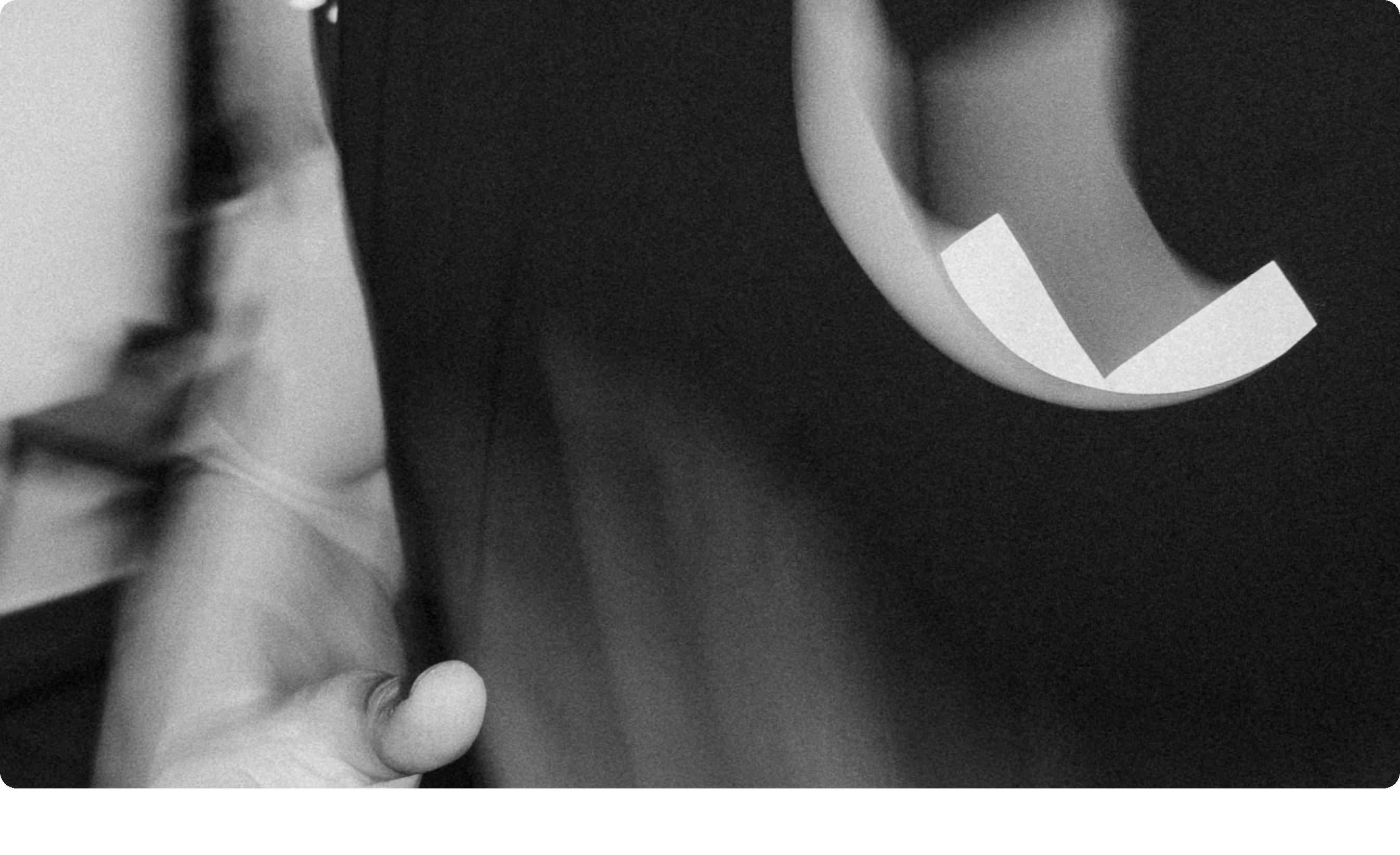 A cinematic, grain-textured black-and-white visual interlude creating a moody, abstract pause.